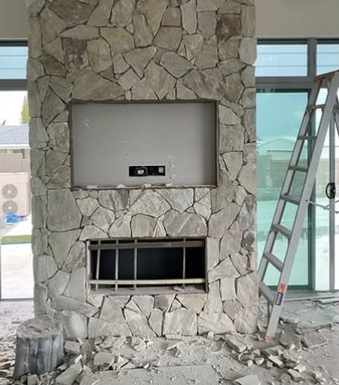 Natural stone cladding on a fireplace wall